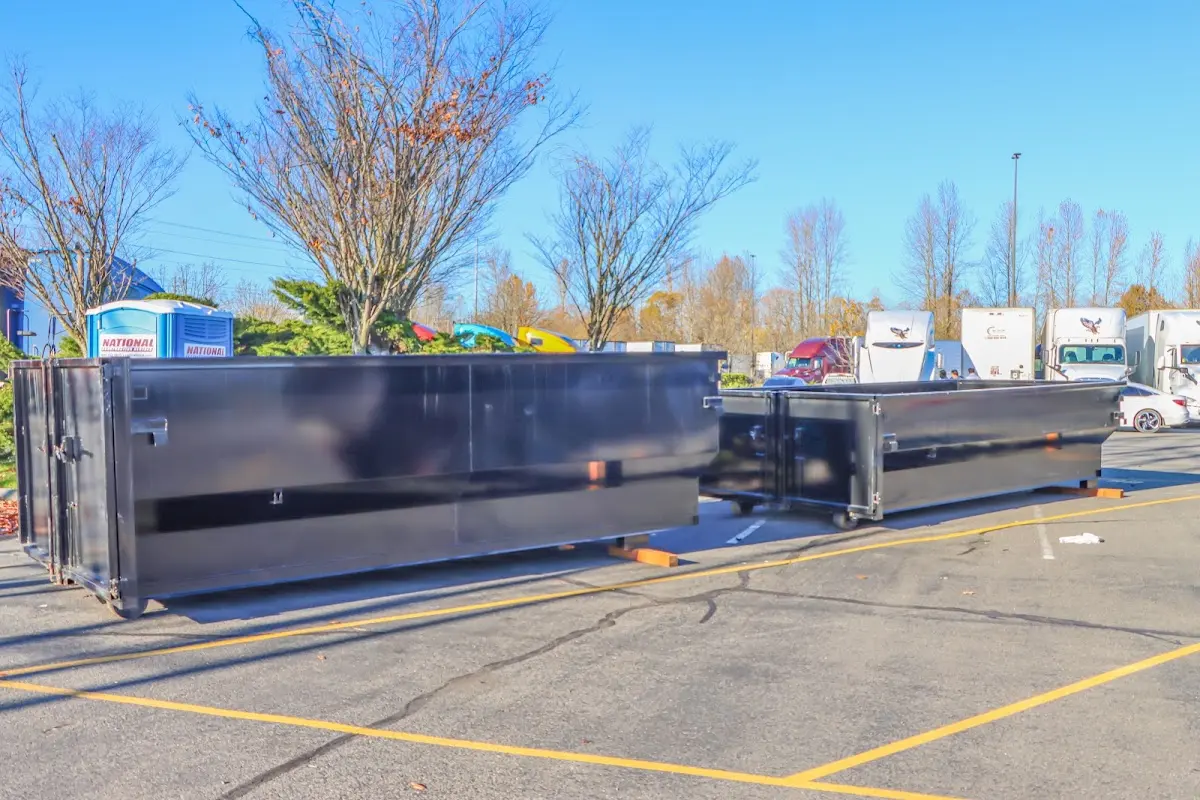 Professional dumpster rental service with roll-off container on residential driveway in Ansonia